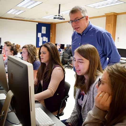 Dr. Kevin Page teaches students who are working at computer stations